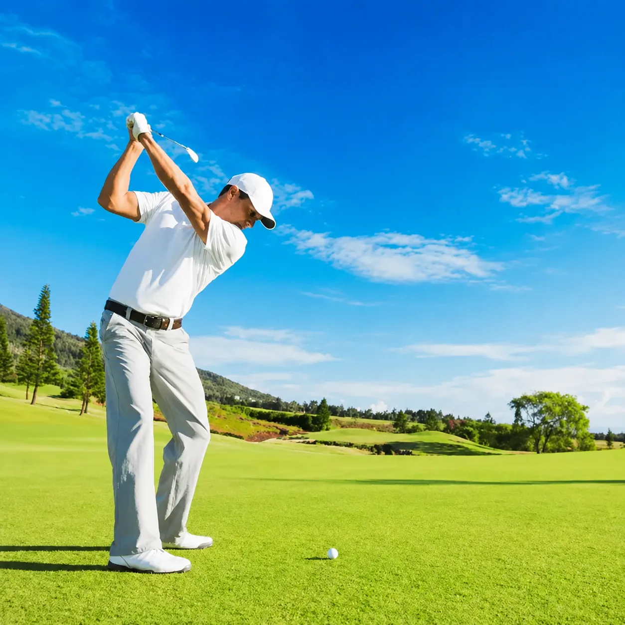 Golfer completing a full swing during a golf movement assessment