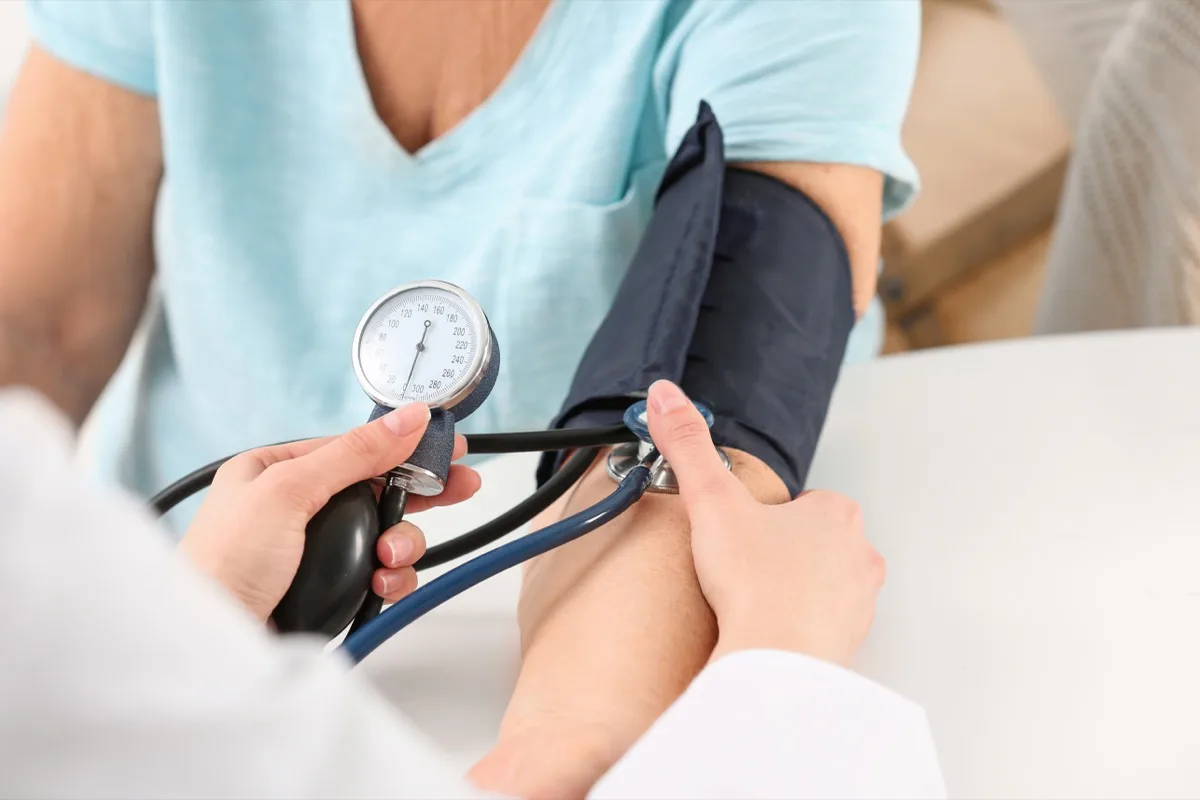 Nurse measuring blood pressure during a home visit on the Costa del Sol